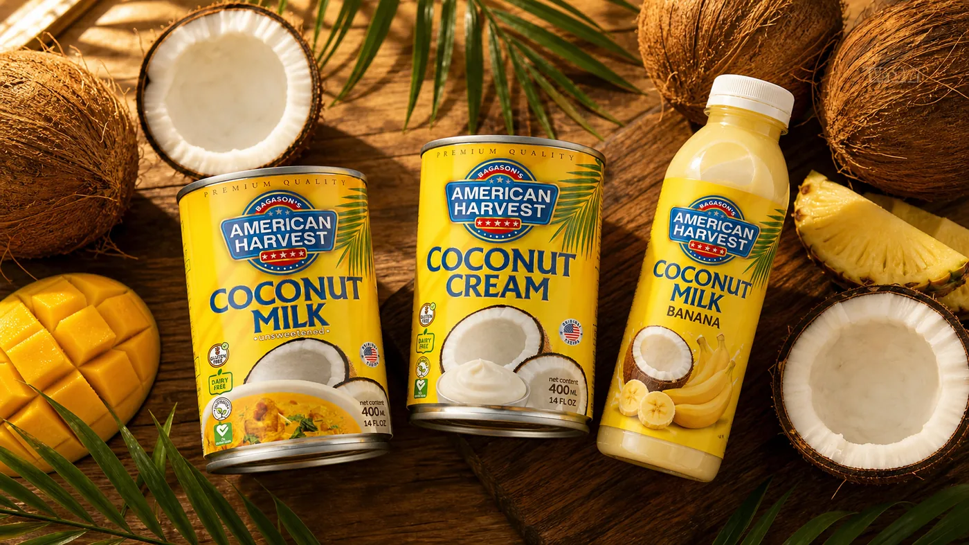 American Harvest coconut milk and coconut cream cans with a split coconut and a creamy curry bowl